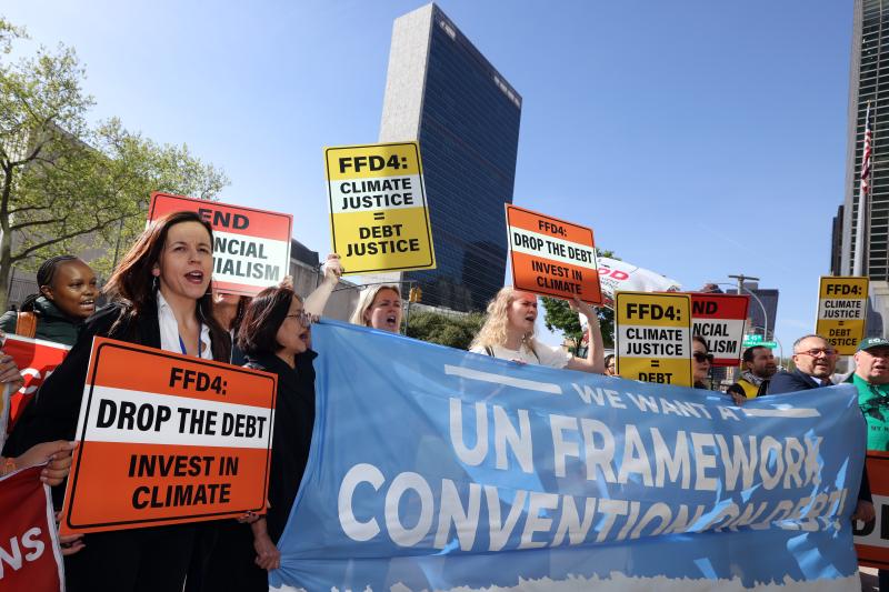 Protest for a UN declaration on debt at the UN Financing for development meeting 2025. People holding banners and placards