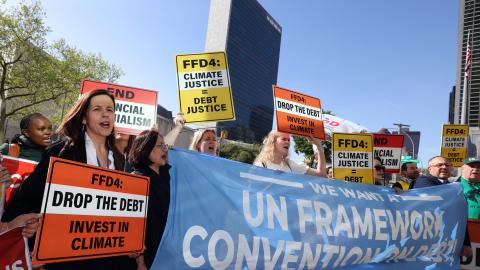Protest for a UN declaration on debt at the UN Financing for development meeting 2025. People holding banners and placards